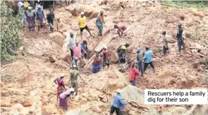  ??  ?? Rescuers help a family dig for their son