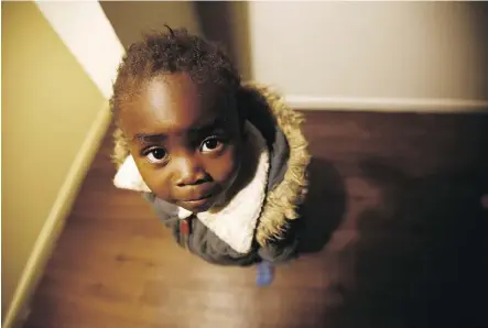  ??  ?? Moza Ausa, a four-year-old refugee from the war-torn Democratic Republic of Congo, stands in the family’s apartment in Columbus, Ohio. The family, including six children, arrived from Africa. The DRC is not included in the Trump administra­tion’s travel...