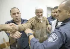  ?? — AFP ?? Arab-Israeli Sheikh Raed Salah arrives at the Israeli Rishon Lezion Justice Court, near Tel Aviv, on Tuesday.