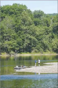  ?? NWA Democrat-Gazette/FLIP PUTTHOFF ?? Kayakers beach boats on a gravel bar July 1 along the cold-flowing White River below Beaver Dam. The stream is a haven for summertime kayaking, canoeing and fishing.