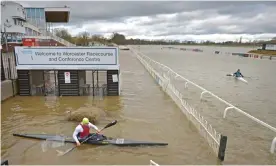  ??  ?? Members of Worcester Canoe Club kayaking on a flooded Worcester racecourse. Photograph: Jacob King/PA