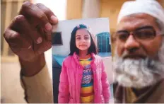  ?? AP ?? Mohammad Amin shows a picture of his 7-year-old daughter, Zainab Ansari. Zainab’s killer will be hanged on Wednesday.