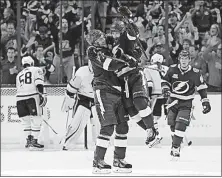  ?? [CHRIS O’MEARA/THE ASSOCIATED PRESS] ?? Tampa Bay’s Nikita Kucherov, center, gets a lift from teammate Victor Hedman after Kucherov scored against Pittsburgh on Saturday.