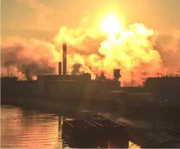  ?? — AFP file photo ?? Smoke billowing over a plant in a suburb of Lille on Dec 5, 2015 in Lille, northern France