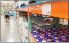  ??  ?? A shopper guides a cart past a line of gigantic boxes of breakfast cereals in a Costco warehouse on Thursday, June 17, 2021, in Lone Tree, Colorado. (AP)