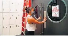  ?? JENNIFER LETT/SUN SENTINEL ?? Lindsay Ashby, manager of Cyclebar, had the gym cleaned Friday to prep for its reopening in Fort Lauderdale.