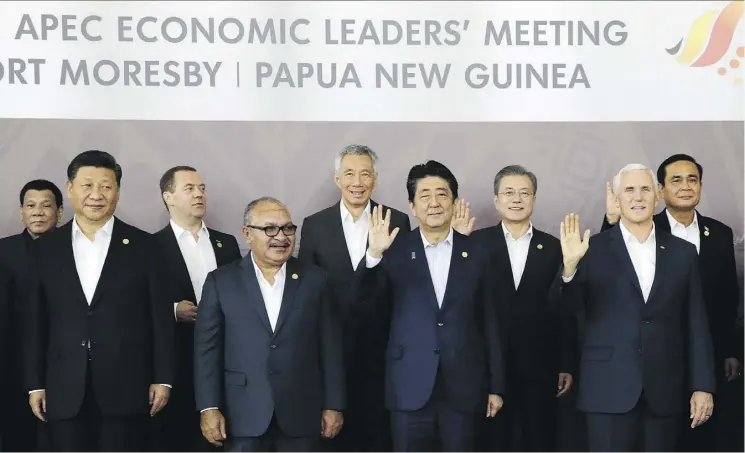  ?? AARON FAVILA/THE ASSOCIATED PRESS ?? Chinese President Xi Jinping, foreground far left, and U.S. Vice-President Mike Pence, foreground far right, stand with other APEC leaders in Port Moresby, Papua New Guinea, on Sunday. As China and the U.S. manoeuvre for influence across the region, the biggest worry is that the jousting could escalate into a full-blown confrontat­ion.