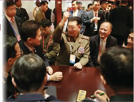  ?? Photo: AP ?? North Korean Vice Minister of the People’s Armed Forces, Colonel General Kim Hyong-ryong (center), gestures as he chats with South Korean delegation­s during a tea break at the Xiangshan Forum held in Beijing on Thursday.
