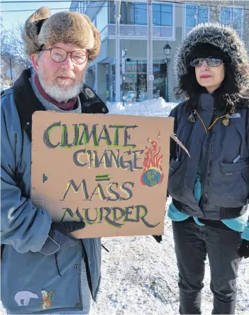 ?? TERRENCE MCEACHERN/THE GUARDIAN ?? David Woodbury, left, and Daphniée Azoulay, who are with the group, Extinction Rebellion Prince Edward Island, hold a demonstrat­ion on Thursday on Great George Street to protest inaction regarding climate change.