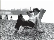  ??  ?? Terry Jones posing for a photograph on Brighton Beach in 1989