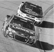  ?? JEFF ZELEVANSKY/GETTY IMAGES ?? Jimmie Johnson, left, leads Kevin Harvick in Sunday’s race. Harvick led a race-high 131 laps but wound up 6th.