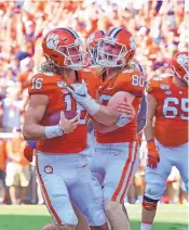  ?? RICHARD SHIRO/ASSOCIATED PRESS ?? Clemson’s Trevor Lawrence, left, and Luke Price celebrate a score last week against Texas A&M. The topranked Tigers face Syracuse Saturday.