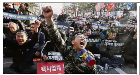  ?? — AP ?? Up in arms: Taxi drivers shouting slogans during a rally against a commercial carpool service near the National Assembly in Seoul.