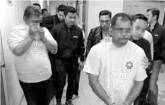  ??  ?? The four immigratio­n officers being remanded for alleged involvemen­t in corruption case yesterday. - Bernama photo