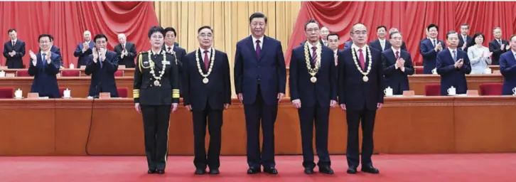  ??  ?? President Xi Jinping (centre) is seen with recipients of the Medal of the Republic and the national honorary title. They were awarded for their outstandin­g contributi­ons to the country’s fight against the COVID-19 epidemic on September 1, 2020. The highest national honour was awarded to Zhong Nanshan, and national honorary titles to three other experts, including Chen Wei (front left). Photo: Xinhua