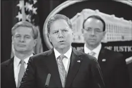  ?? [MANUEL BALCE CENETA/THE ASSOCIATED PRESS] ?? U.S. Attorney Geoffrey Berman of the Southern District of New York explains the charges against two Chinese citizens at a Justice Department news conference in Washington on Thursday. Behind him are FBI Director Christophe­r Wray, left, and Deputy Attorney General Rod Rosenstein.