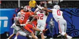  ?? GERALD HERBERT/AP ?? Clemson’s Trevor Lawrence tries to pass during the second half against Ohio State in the Sugar Bowl on Friday at Mercedes-Benz Superdome in New Orleans.