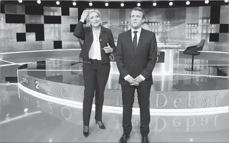  ?? Eric Feferberg Pool Photo ?? FRENCH CANDIDATES Marine Le Pen, left, of the far right and Emmanuel Macron, a centrist, disagreed over how to deal with unemployme­nt, terrorism, taxes and health provisions. Both were hoping their face-to-face debate would sway undecided voters.