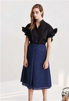  ??  ?? “This beautiful navy raffia skirt is one of my favourite versatile pieces. It’s also got a little bit of shimmer – something our Singapore customers really love.” Iris & Ink poplin top, £75 (S$133), and raffia skirt, £150.