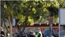  ?? PHOTO: KEVIN FARMER ?? FAREWELL: Mourners gather to pay their respects to Senior Constable Brett Forte.