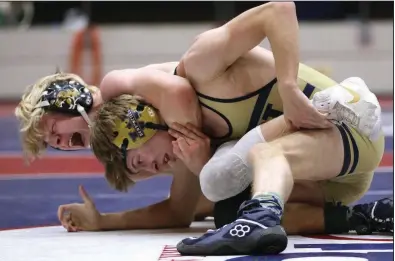  ?? More photos available at arkansason­line.com/36wrestlin­g. ?? Bentonvill­e’s Tristan Stafford (left) pulls down Tyler Holmes of Bentonvill­e West in the 120-pound championsh­ip match at the Class 6A boys state wrestling tournament Friday at the Jack Stephens Center in Little Rock. Stafford won the match and the Tigers claimed the Class 6A team title.