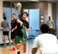  ?? NANCY LANE / BOSTON HERALD ?? TEAMWORK: Carsen Edwards pitches a T-shirt to Tremont Waters during a Celtics workout earlier this month at the Auerbach Center.