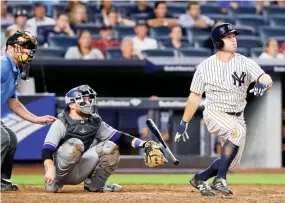  ??  ?? New York Yankees’ Brett Gardner follows through on a solo home run that tied the score against the Texas Rangers during the ninth inning in New York on Friday. (AP)