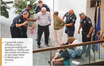  ??  ?? Capitol Hill police officers arrest a group protesting the Republican health care bill outside the offices of Sen Dean Heller in Washington on Monday.