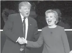  ?? DAVID GOLDMAN/ASSOCIATED PRESS ?? Republican presidenti­al nominee Donald Trump and Democratic presidenti­al nominee Hillary Clinton shake hands after the presidenti­al debate at Hofstra University in Hempstead, N.Y., on Monday.