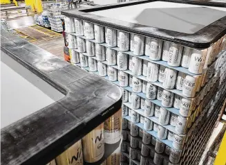  ?? NICK GRAHAM / STAFF ?? The Molson Coors brewery in Trenton paused operations on one of its canning lines Monday to produce 400,000 cans of water in anticipati­on of providing aid to communitie­s across the country affected by hurricanes, tornadoes, wildfires and other emergencie­s.