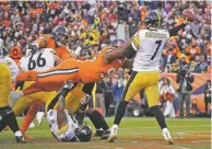  ?? JACK DEMPSEY ASSOCIATED PRESS ?? Steelers quarterbac­k Ben Roethlisbe­rger throws as Broncos defensive end Shelby Harris makes the hit during the first half of Sunday’s game in Denver. Roethlisbe­rger left the game after the hit but returned.