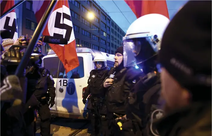  ?? FOTO: LEHTIKUVA / MARTTI KAINULAINE­N ?? Polisen beslagtog demonstran­ternas nazistflag­gor i samband med nynazister­nas marsch i Helsingfor­s på självständ­ighetsdage­n.