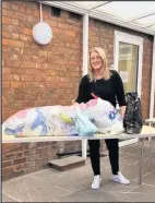  ??  ?? ■ ‘Helping Hand’s co-founder Kelly Ruthven with some of the uniform bags.