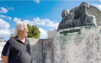  ?? ?? Mario Darias observes the bronze busts of the tomb of the couple Margarita Pacheco and Modesto Canto, known as ‘The Tomb of Love,’ at Colon Cemetery in Havana.