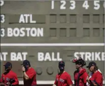  ?? BRYNN ANDERSON - THE ASSOCIATED PRESS ?? The Boston Red Sox’s players walk on the field before a spring training baseball game against the Atlanta Braves on Monday, March 1, 2021, in Fort Myers, Fla.