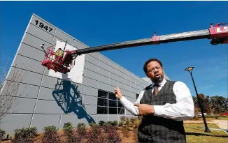  ?? CURTIS COMPTON / CCOMPTON@AJC.COM ?? Khalfani Stephens, executive director of the Developmen­t Authority of Clayton County, points to the massive LTI Inc. food service equipment manufactur­er in Jonesboro as an example of the achievemen­ts the county’s economic developmen­t team wants more of.