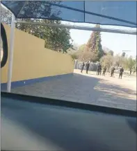  ??  ?? Police in riot gear milling outside Beatrice Mtetwa’s offices (left) and in the second frame, driving past the offices in Harare yesterday