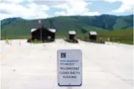  ?? The Associated Press ?? ■ The entrance to Yellowston­e National Park, a major tourist attraction, sits closed due to the historic floodwater­s on Wednesday in Gardiner, Mont.