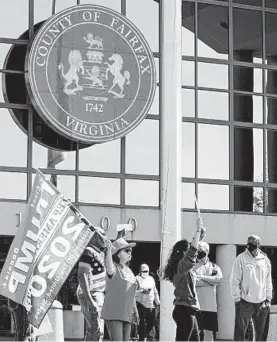  ?? KENNY HOLSTON/THE NEW YORK TIMES ?? Supporters of President Trump seen Sept. 19 outside the Fairfax County Government Center in Fairfax, Va. Trump wants his supporters to monitor polling places.