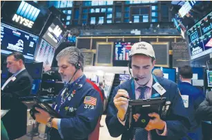  ?? (Andrew Kelly/Reuters) ?? TRADERS WORK on the floor of the New York Stock Exchange in New York City, last week.