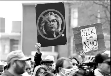  ?? MICHAEL CUMMO / THE WYOMING TRIBUNE EAGLE VIA AP ?? Protesters hold signs opposing Rep. Liz Cheney, R-Wyo., during a rally Jan. 28 outside the Wyoming State Capitol in Cheyenne.