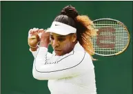  ?? Clive Brunskill / Getty Images ?? Serena Williams plays a backhand during a training session Saturday ahead of Wimbledon.