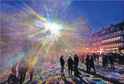  ?? MICHAEL PROBST / ASSOCIATED PRESS ?? Light shines out from a building in Roemer Square during the official opening of the “Luminale” light festival in Frankfurt, Germany, on Tuesday.