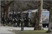  ?? ASSOCIATED PRESS FILE PHOTO ?? Russian army soldiers stand next to their trucks during a rally against Russian occupation in Svobody (Freedom) Square in Kherson, Ukraine, on March 7.