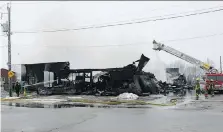  ?? ELLWOOD SHREVE ?? This warehouse, owned by Tom & Al’s Quality Furniture Store in Wallacebur­g, was destroyed by fire on Saturday. Nobody was injured in the early morning blaze.