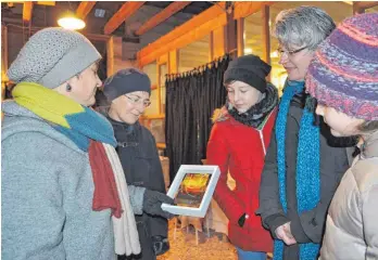  ?? FOTO: WALTRAUD WOLF ?? Astrid Hille (links) erläutert interessie­rten Besucherin­nen der Weihnachts­ausstellun­g in Mörsingen, wie ihre „Engelsbild­er“entstehen.