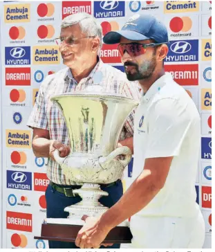  ?? M. PERIASAMY ?? Well-deserved win: Ajinkya Rahane receives the Duleep Trophy from R. S. Ramasaamy, secretary of the Tamil Nadu Cricket Associatio­n, in Coimbatore. Thanks in main to Yashasvi Jaiswal and Sarfaraz Khan, West Zone turned it around after conceding a lead of 57 runs in the first innings.