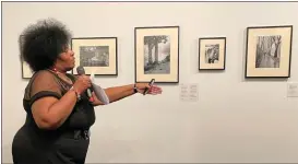  ?? DAVID ALLEN — STAFF ?? Brenda Fredericks speaks against a backdrop of KD Ganaway photos during the opening of an exhibit of his work at Riverside’s California Museum of Photograph­y. Fredericks and her husband, who is Ganaway’s great-grandson, have been researchin­g the early Black photograph­er’s life.