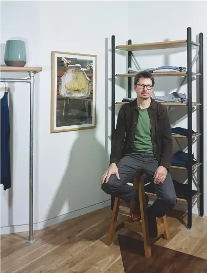  ??  ?? OLIVER SPENCER IN HIS NEW NOTTING HILL BOUTIQUE. IT FEATURES BESPOKE SHELVING BY SPENCER’S LONG-TIME COLLABORAT­ORS, BRITISH BRAND ANOTHER COUNTRY