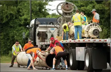  ?? NWA Democrat-Gazette/BEN GOFF • @NWABENGOFF ?? Volunteers unload sections of a giant telescope from a truck Saturday for temporary storage at 8th Street Market in Bentonvill­e. Swarthmore College in Swarthmore, Pa., donated the 106-year-old telescope to Supporting STEM & Space, a Northwest Arkansas...